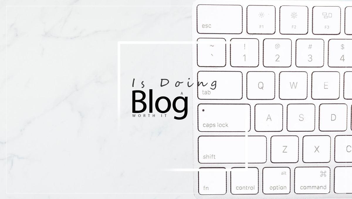 Keyboard on a marble background with the inscription: Is doing a blog worth it